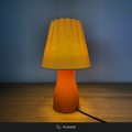 Carmen table lamp lit, warm amber glow, textured shade and base