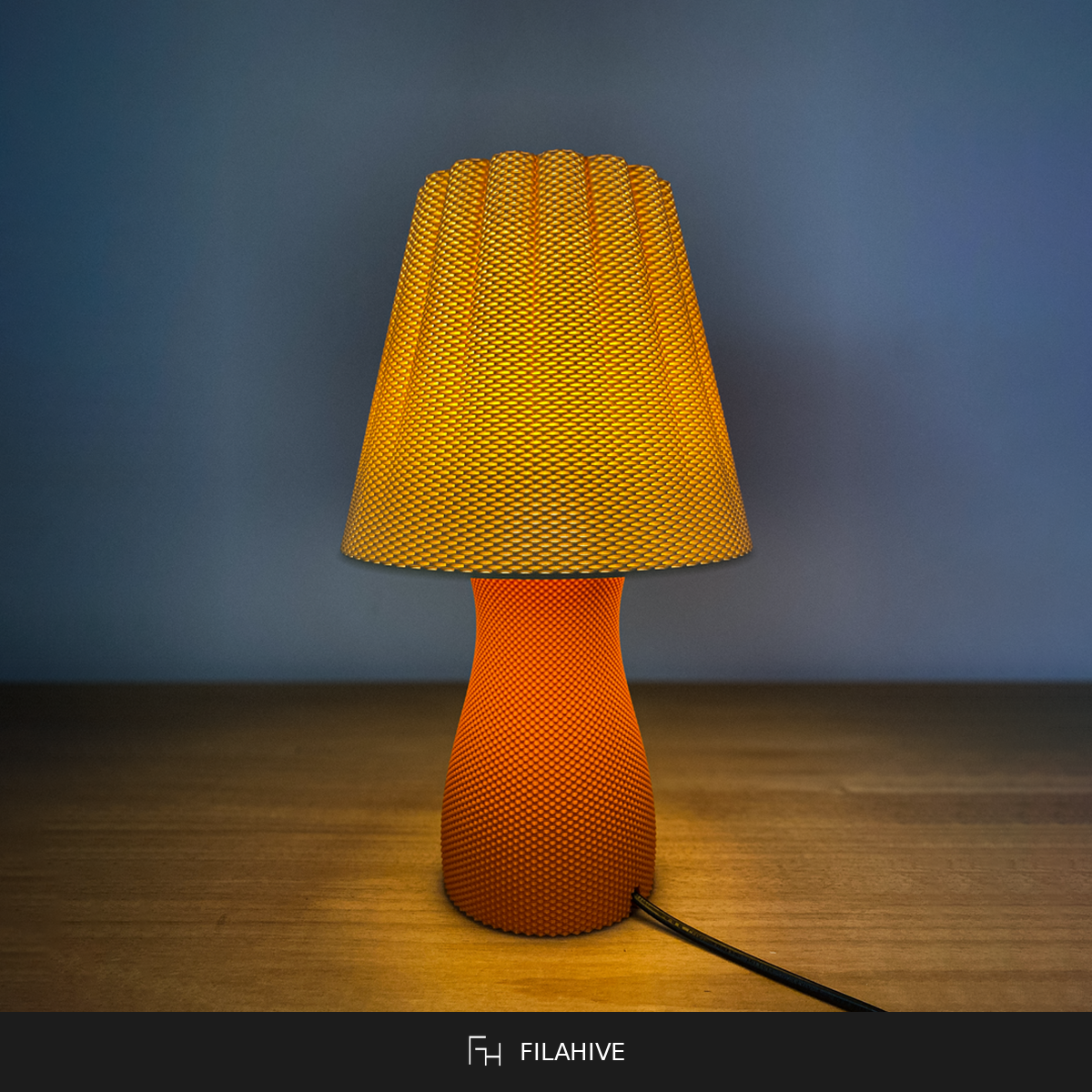 Carmen table lamp lit, warm amber glow, textured shade and base