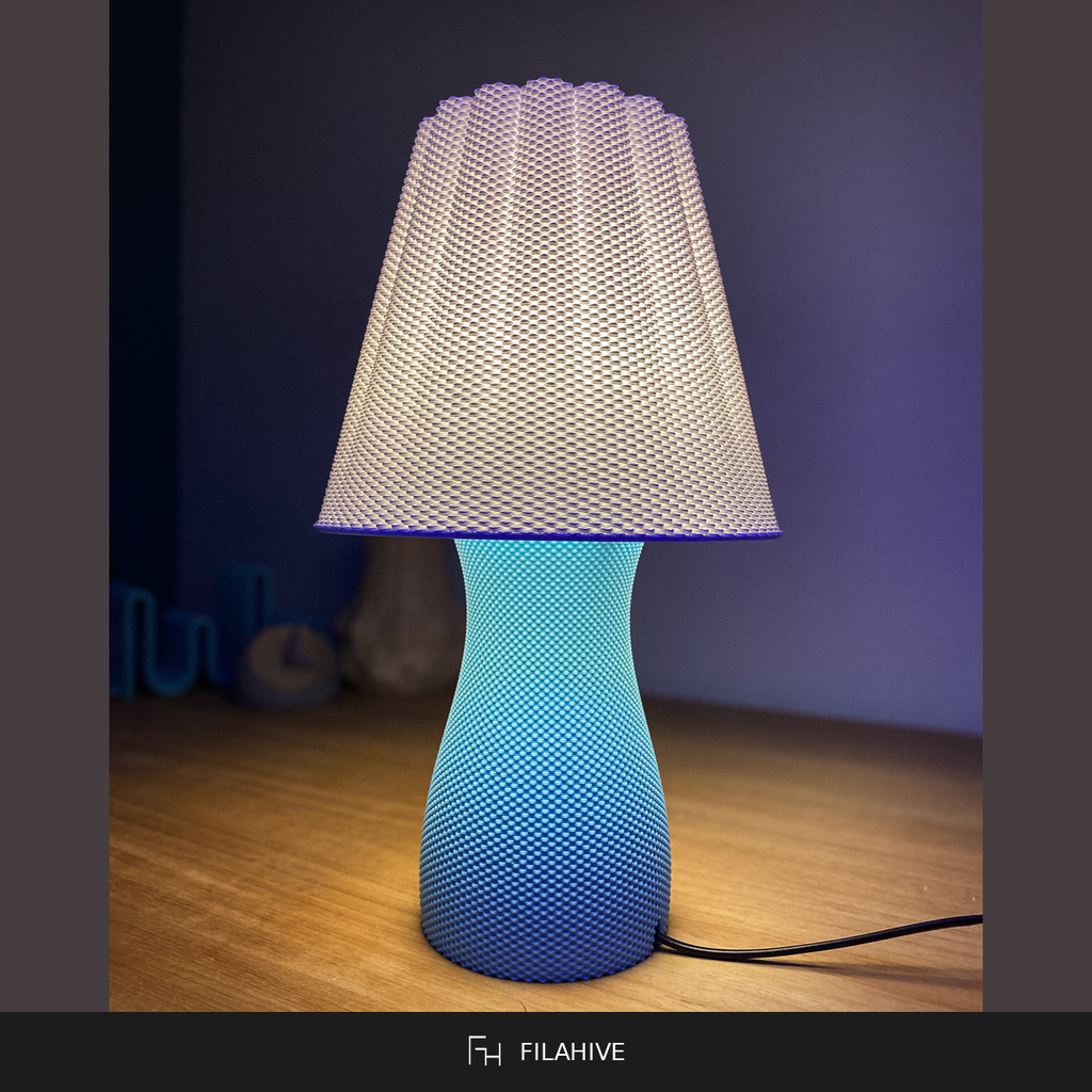 Carmen table lamp lit in blue, ambient mood lighting